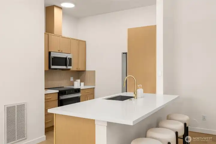 New sleek quartz countertops are perfect for this newly refinished kitchen.