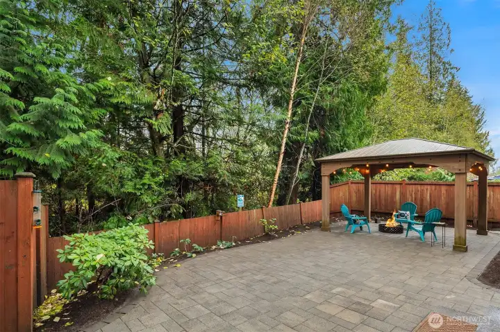 Very serene and private fenced back yard featuring low maintenance paver patio and gazebo.