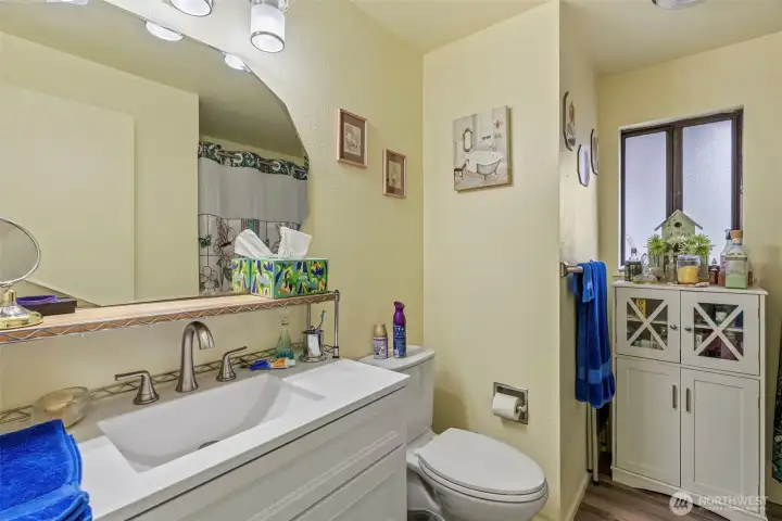 Bright and functional bath with modern updates. New sink, faucets, Unit 1 has a tub shower unit.