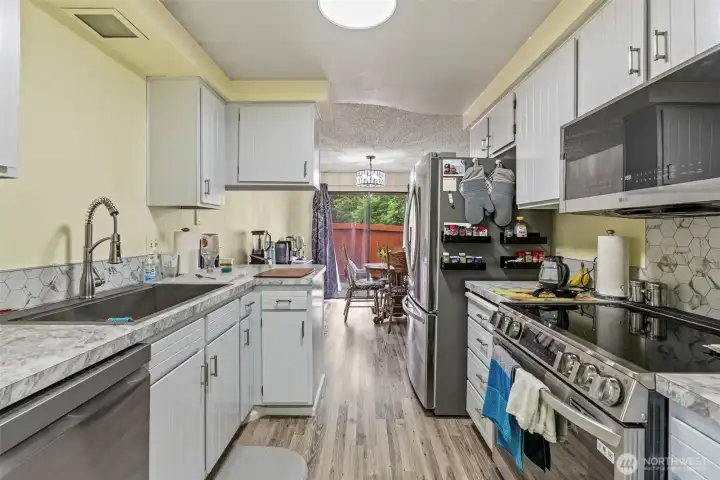 New modern sink and faucet as well as new cabinet hardware and updated lighting.