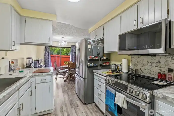 Kitchen is open to the dining room. Unit 1 has a fenced patio area for privacy. New stainless LG appliances that stay with the units.