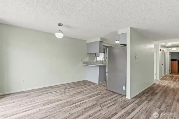 Dining room with new modern lighting open to the kitchen.