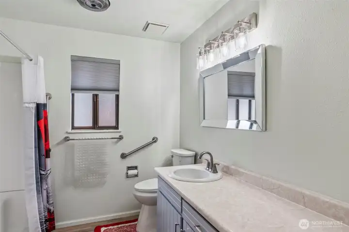 Updated bathroom with refreshed finishes and clean design, large walk in shower and new faucets and lighting.