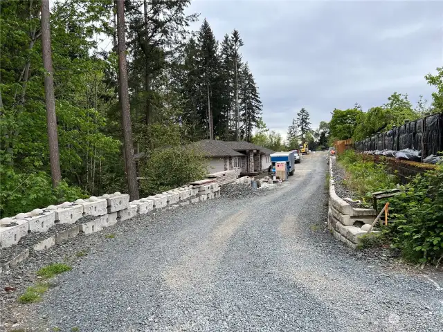 Adjacent and similar neighboring property to the South (right). Single Family home under construction.