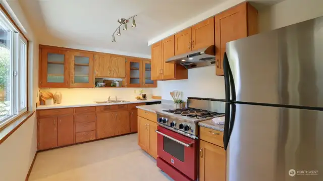 Under cabinet lighting, stainless appliances and a Blue Star gas cooktop.