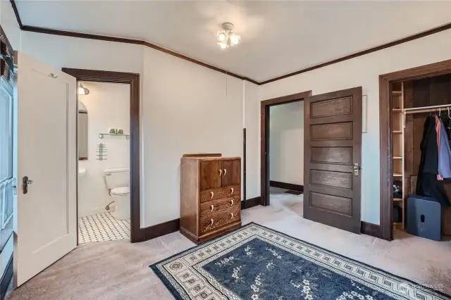 Primary suite with door leading to full bathroom.