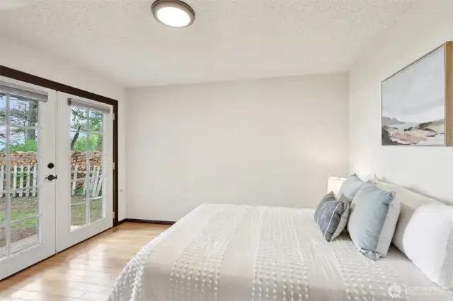 Main floor bedroom with French doors to a private patio.