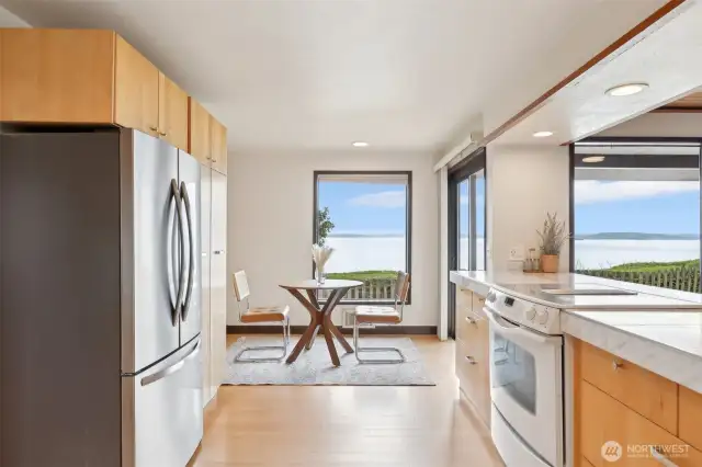 Another view of the kitchen and eating space with corner windows.