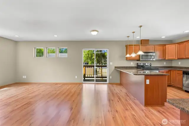 Living room and kitchen with door to deck