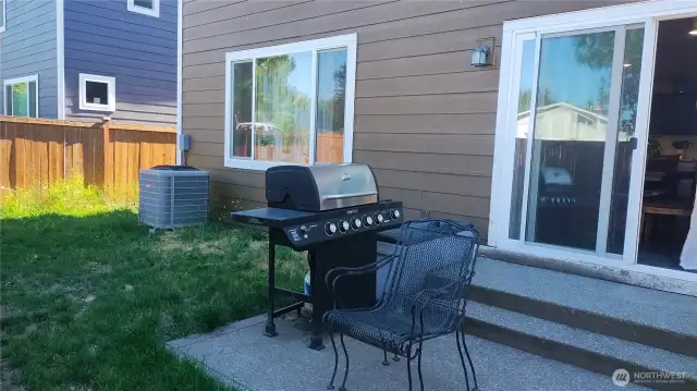 Fenced backyard with patio.  Notice the AC unit