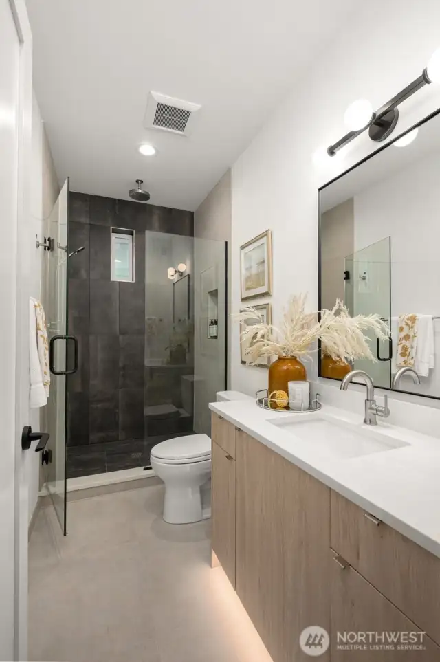 Spa-like ensuite bath with dual sinks, walk-in shower, and contemporary finishes.