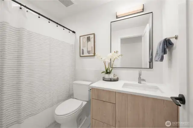 Stylish full bath with timeless tilework and generous lighting.