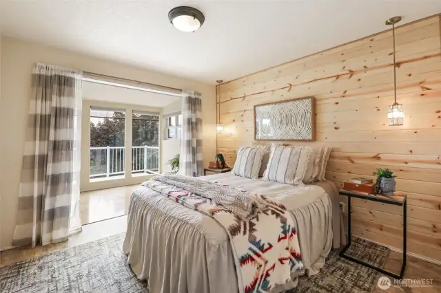 Beautiful natural wood accent wall in the guest bedroom. Curtains will be replaced with french doors!