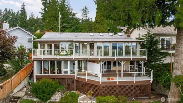 Beautiful back of the home highlighting all of the view windows and deck space!