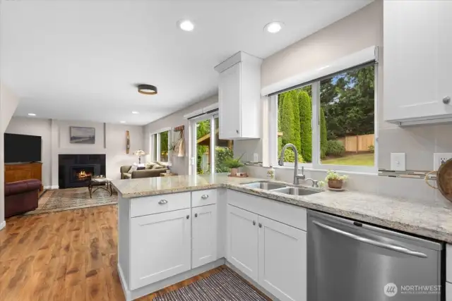 Beautiful, sun-drenched kitchen and living room. Neutral granite counters will flow with any decor!