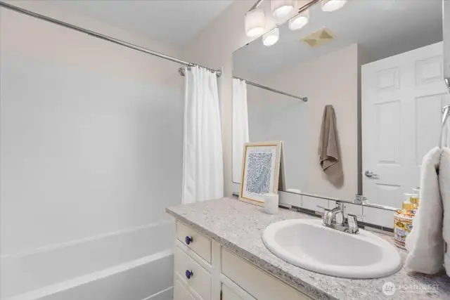 Upstairs guest bathroom with shower & tub