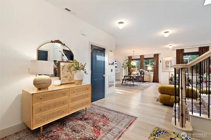 Welcome inside! The entry was thoughtfully reimagined to create a more open and connected layout, offering a clear line of sight into the heart of the home. Durable and stylish luxury vinyl plank flooring flows throughout, adding warmth and cohesion. Natural light, high ceilings, and a soft neutral palette enhance the sense of spaciousness, making this entryway feel both welcoming and refined.