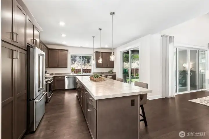 Large kitchen with upgraded Cafe appliances, 36" pantry wih rollout shelves, 12ft island with counter seating