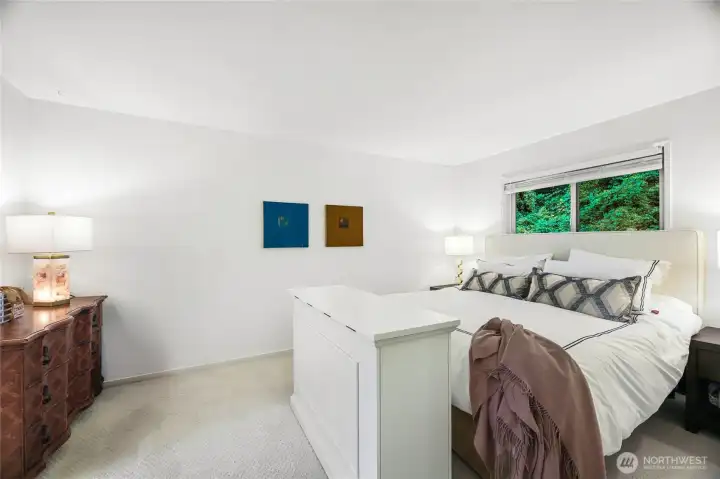 primary bedroom faces the greenbelt behind the building. Walk in closet with built in system.