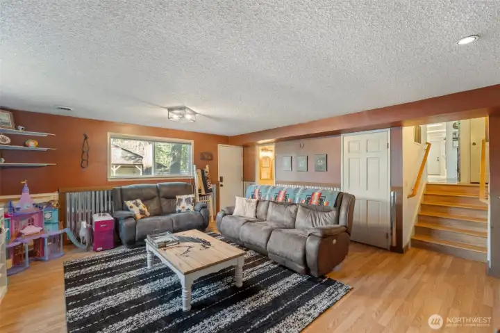 Just off of the kitchen on the lower level find this great family room to unwind. A full bathroom easily accessed in the back corner. Laminate floors add warmth as well as easy maintenance.