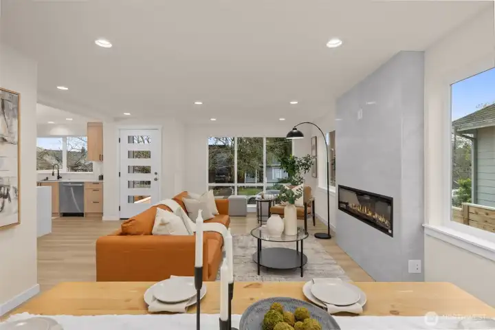 The living room features a statement electric fireplace. Masterfully crafted ceramic tile surrounds building a pristine atmosphere