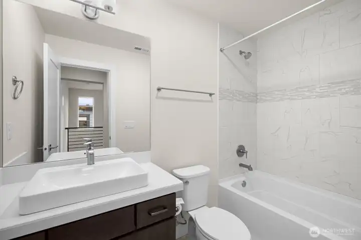 The bathroom is thoughtfully designed with clean finishes and a functional layout that feels both fresh and inviting.