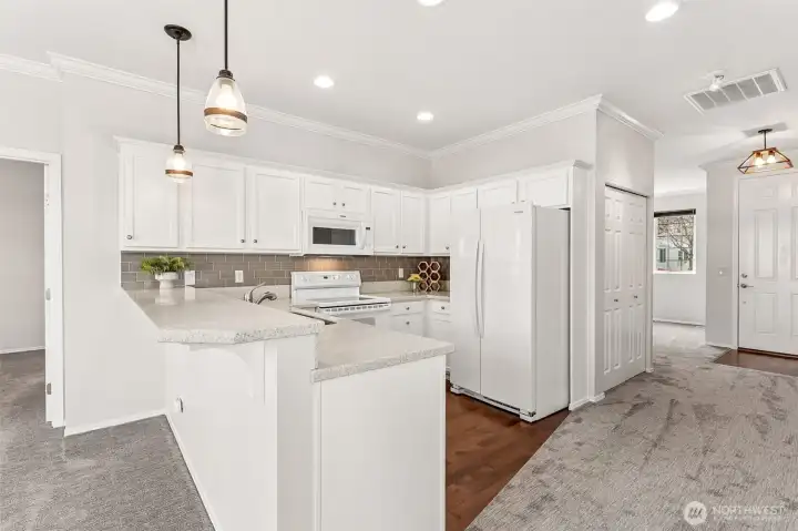 Lovely kitchen w/updated counters, backsplash and lighting