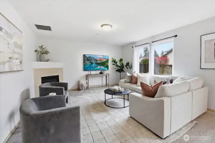 Bright family room off dining and kitchen with newer carpet and gas fireplace.