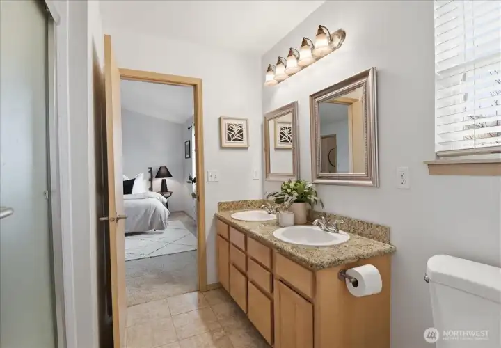 Primary bathroom with a double vanity and new shower installed in 2023.