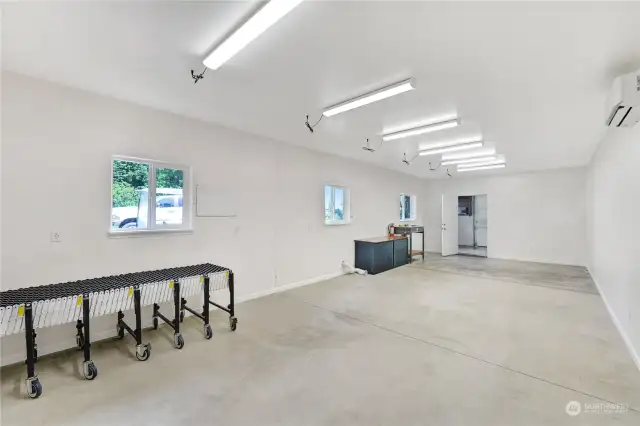 This is the finished space that has been used as a business in the past.  The carpeted office space is at the far end.  There is a man door as well as an up and over door. It's clean and bright with so many possiblities!