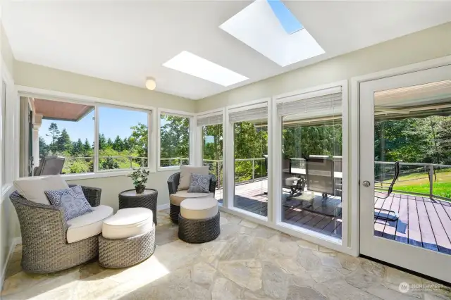 This bright Sunroom has all new Milgard Ultra windows. It leads out to a deck and the Koi ponds. There are some Koi which are 40 years old!