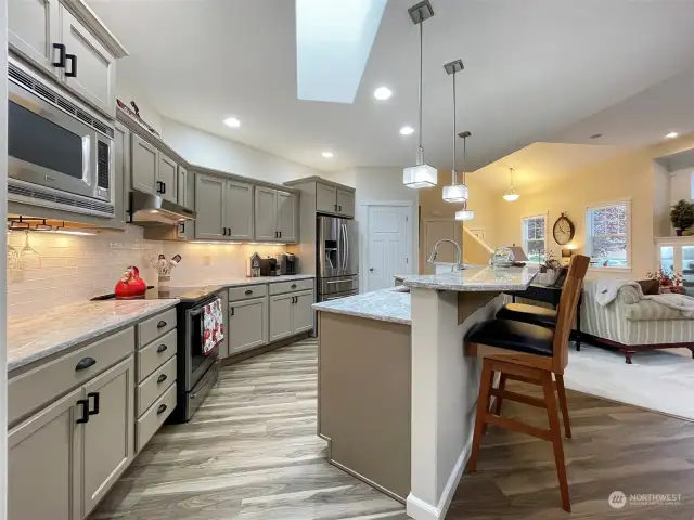 Under cabinet lighting; Stainless steel appliances including induction cooktop on the range; Under cabinet wine glass rack. Skylight.