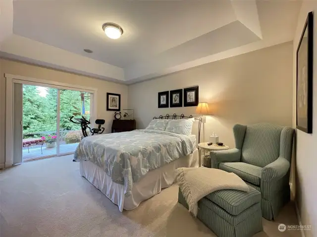 Main floor primary bedroom with coffered ceiling
