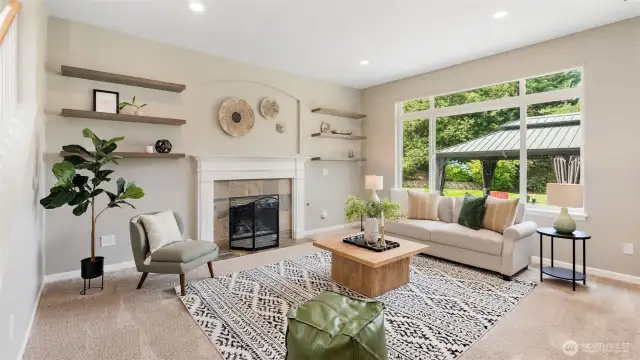 At the back of the main level, you’ll find a wow-worthy living space that’s equal parts cozy and open. A gas fireplace adds warmth and ambiance, while huge windows frame peaceful backyard views - bringing the outdoors in and making this the perfect spot to gather, relax, or unwind.