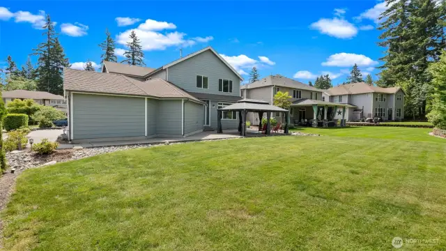 What a backyard! The super flat, gorgeous lawn flows seamlessly into neighboring yards, creating an open and connected feel that invites a true sense of community. It’s the kind of space where spontaneous chats, shared laughter, and neighborhood get-togethers just happen naturally.