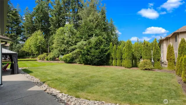 And yet, it's so incredibly private along the back - mature landscaping and thoughtful design give you that tucked-away feeling, making the yard feel like your own personal retreat while still staying connected to the neighborhood vibe.