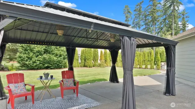 Stunning... and huge! This covered outdoor space offers plenty of room to gather, celebrate, or just kick back - rain or shine. Whether it’s a sunny afternoon BBQ or a cozy evening under the gazebo, there’s space for everyone to feel right at home.