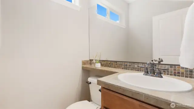The half bath on the main level is a standout - featuring a real vanity (not just a pedestal sink!) that adds both style and storage. It’s the kind of thoughtful touch that makes everyday living just a little easier.