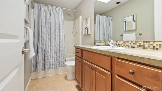 The main upper hall bath is crisp, clean, and ready for daily life - featuring plenty of counter space, great lighting, and a classic layout that makes mornings run smoothly. It’s stylish, functional, and just steps from all the upstairs bedrooms.