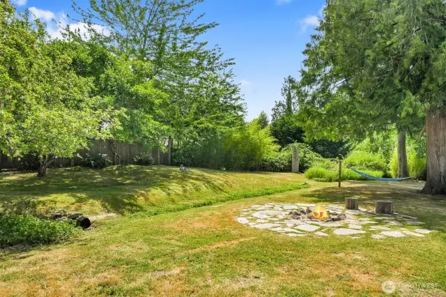 Backyard retreat featuring hammock and natural greenery.