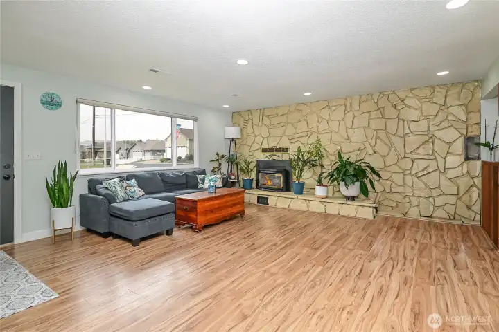 Large family room off entry way with new paint,recessed lighting,hard surface flooring and gas fireplace to keep you warm