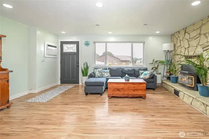 Second view of warm inviting family room off kitchen and entry way with light new paint and windows to keep you happy