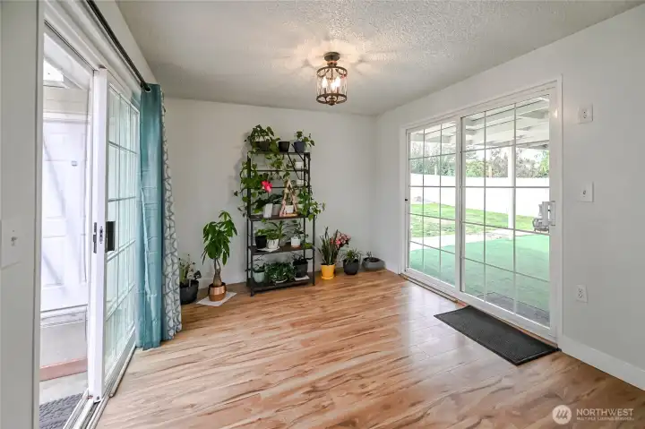 Formal dining room off kitchen with two sliding door on either side leading to courtyard to the left and back yard to the right
