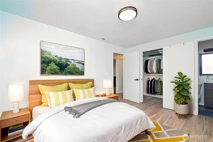 Good sized virtually staged primarty bedroom with walk in closet