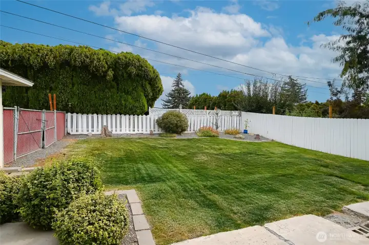 Here is second view of big fully fenced back yard with double gate access to side yard