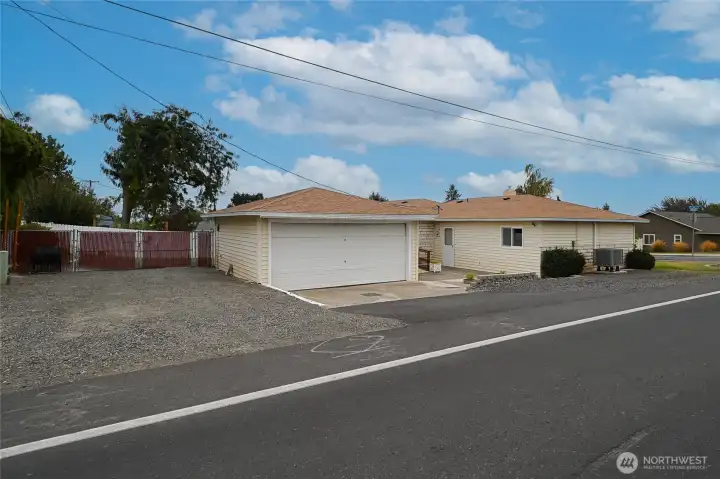 Here is side view of property showing RV boat and extra car parking next to garage
