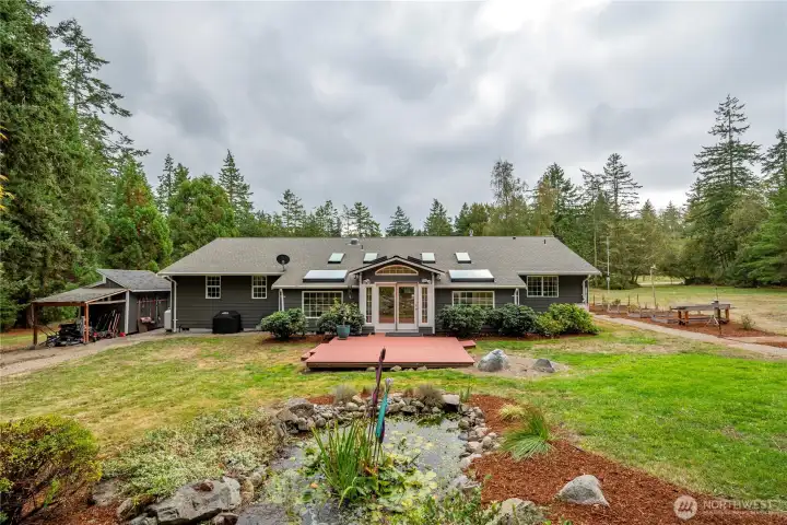 Incredible location with plenty of sun and an expansive back yard. Notice the custom water-fall feature! Raised beds, fruit trees and a large garden shed contribute to the beauty of this unique home!