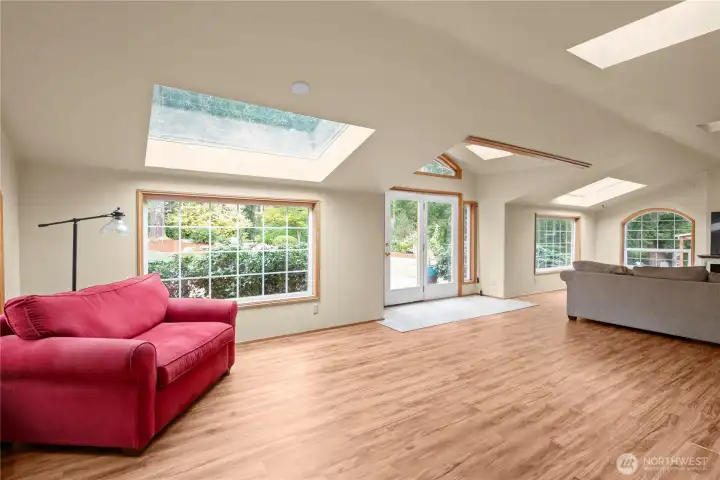 The beautiful sunroom/family room, updated flooring and French doors leading to the back deck.