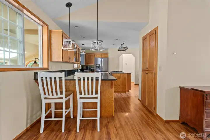 Breakfast bar and a large pantry cabinets to the right.