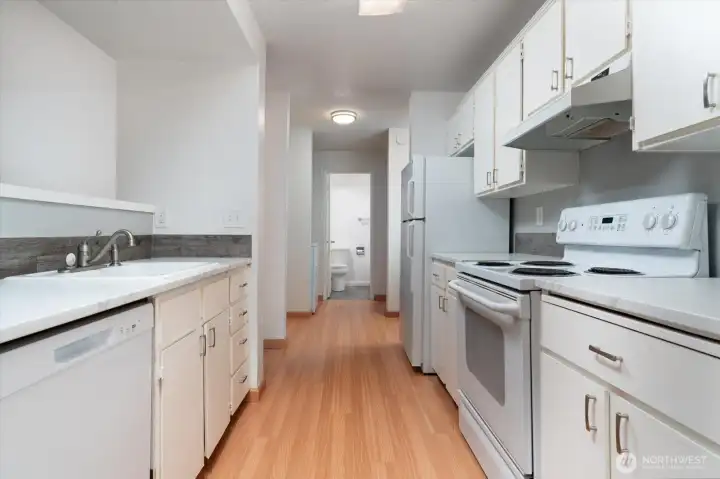 Another view of the Kitchen leading into the entryway.